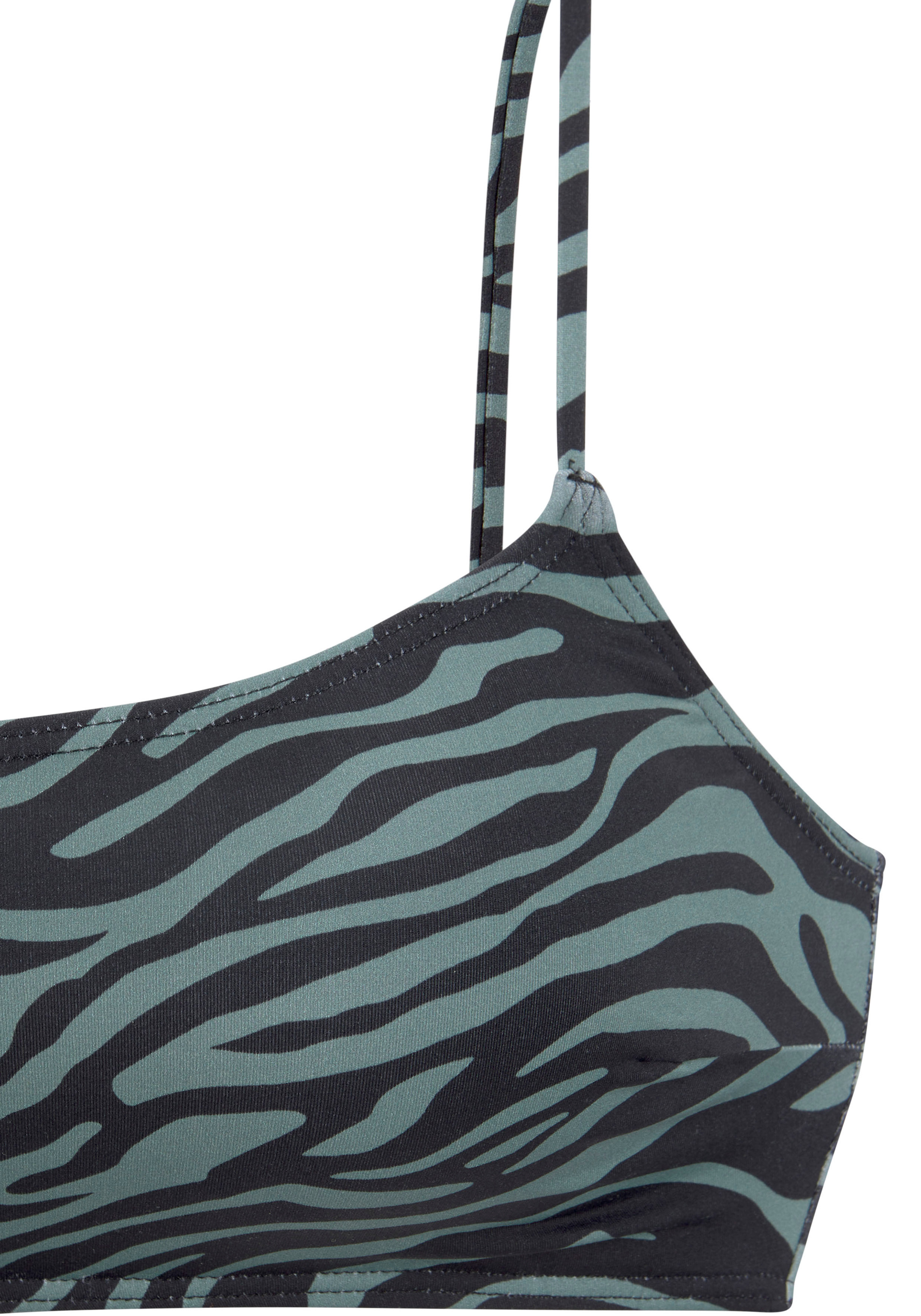 Nahaufnahme eines Bustiers mit schmalen Trägern im Zebra-Muster in Schwarz und Grau auf hellblauem Hintergrund.